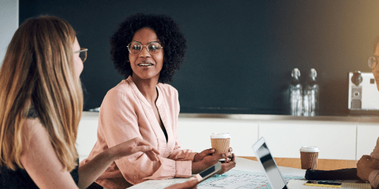 women talking in a boardroom