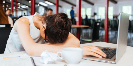 woman sleeping at desk