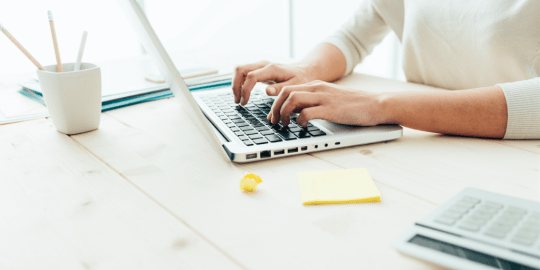 Woman uses email on laptop