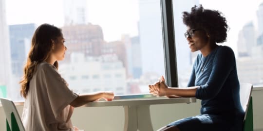 women talking at work