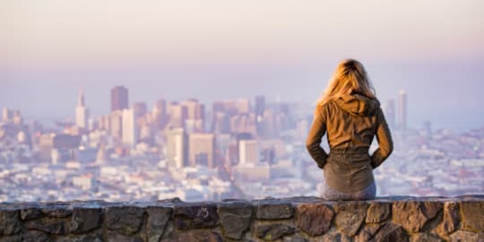 Woman sitting on wall
