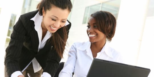 woman mentoring woman at work