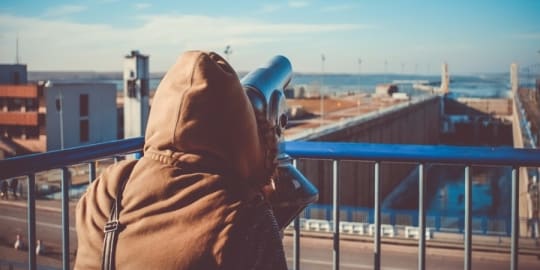 Woman looking through telescope