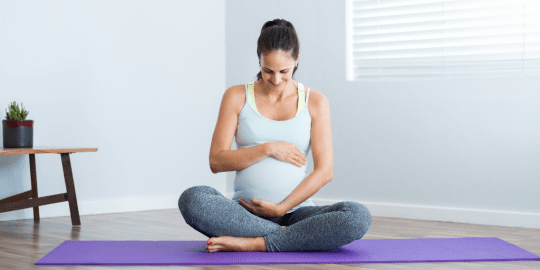 pregnant woman on a yoga mat