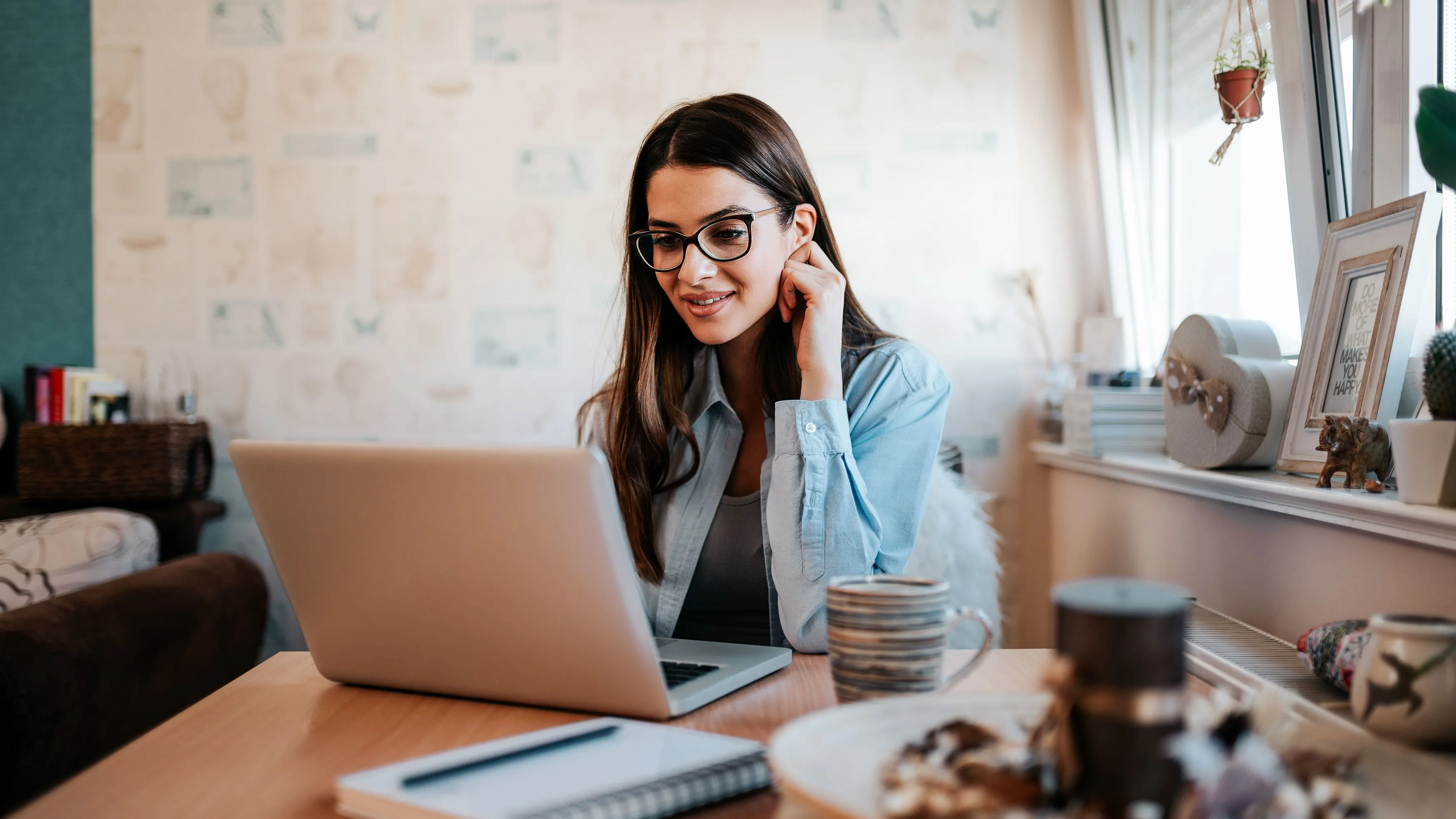 A woman types on a laptop.