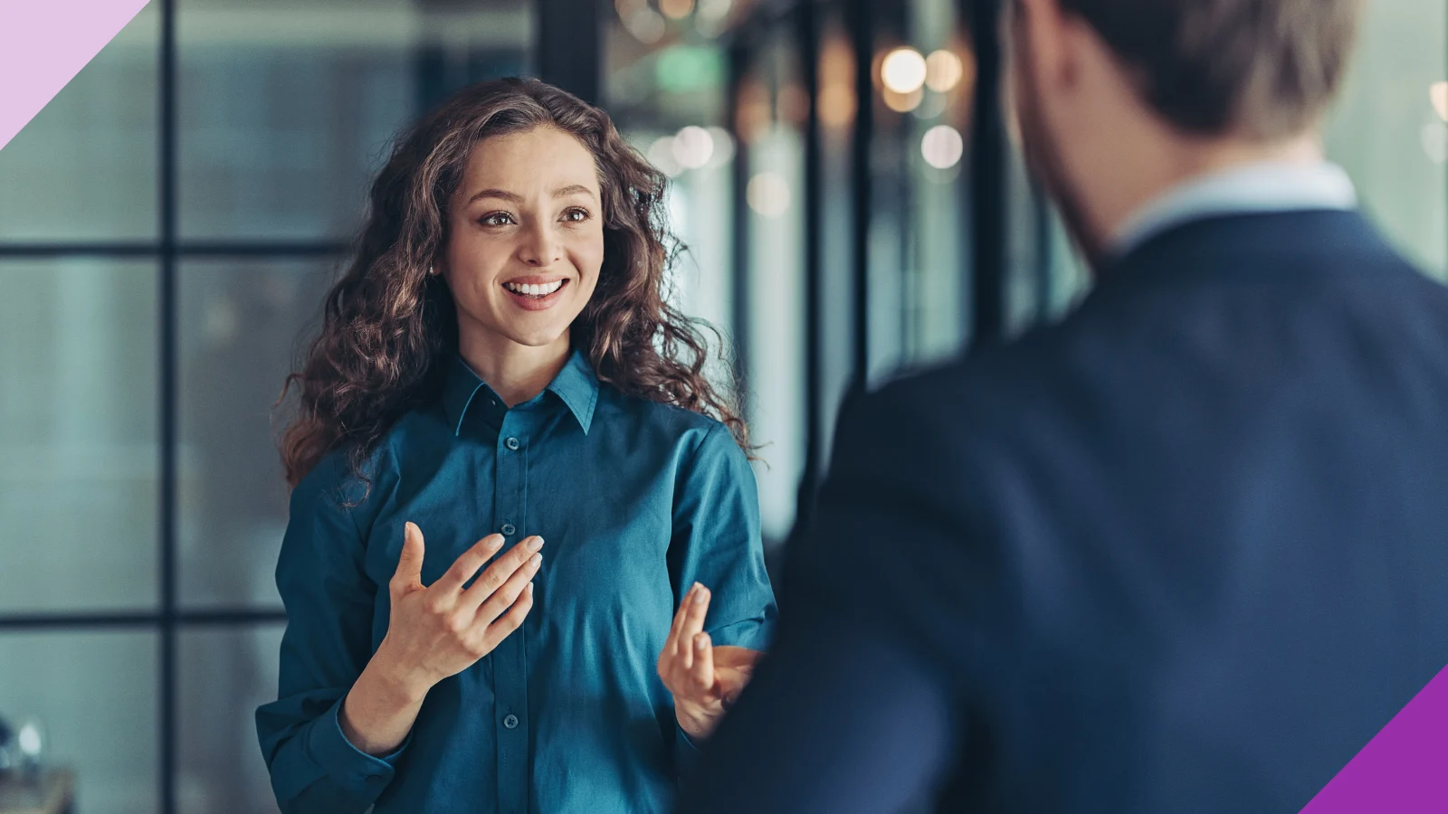 professional woman talking to professional man in person