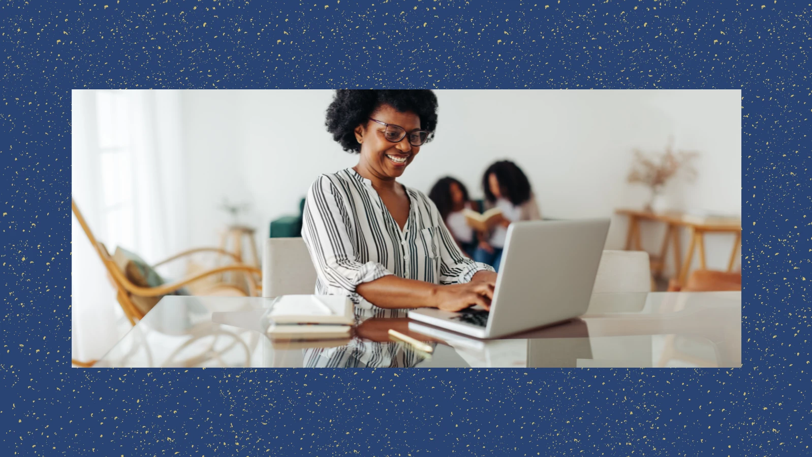 Woman smiling while typing on laptop.
