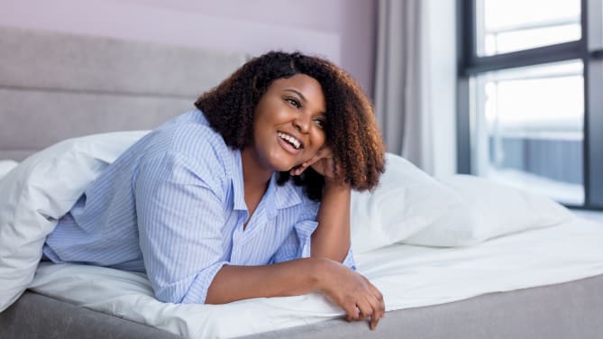woman propped up on bed