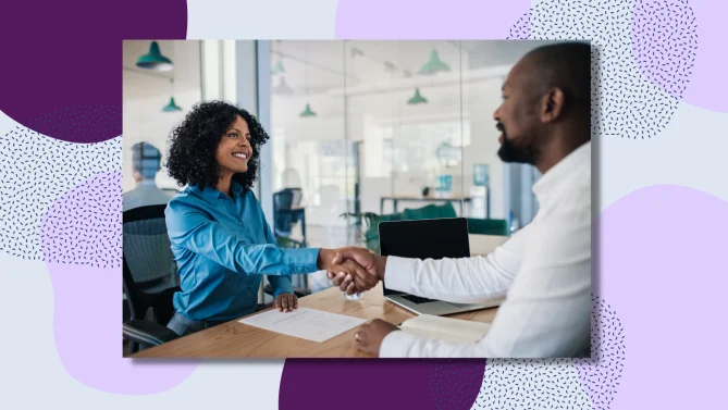 women shaking hands in an interview