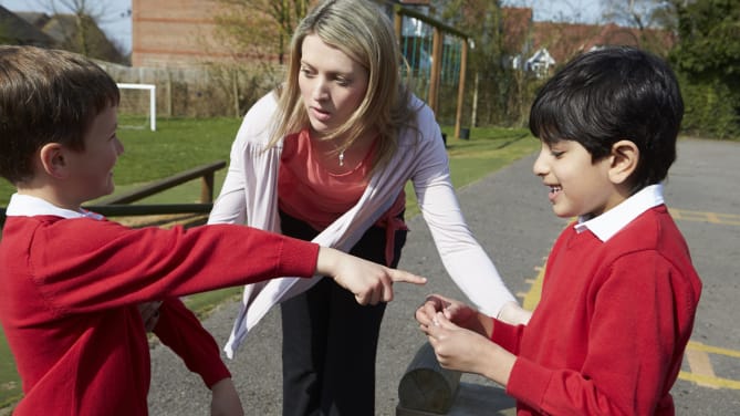 teacher reprimanding students
