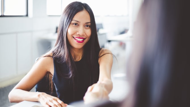 Woman shaking hands with colleague