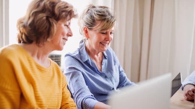 Two women looking at the computer