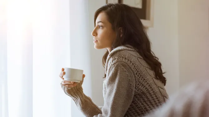 woman looking out window