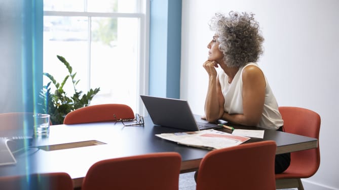 Woman thinking at kitchen table