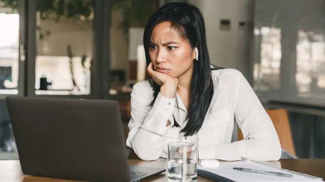 confused woman looking at laptop