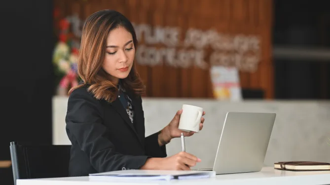 employee reading a letter of reprimand at her desk