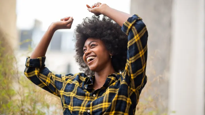 carefree woman dancing outside