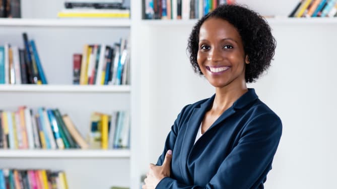 woman standing in front of a bookcase
