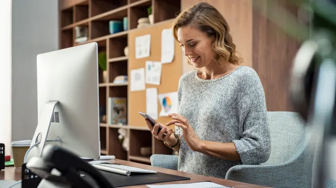 employee checking her phone at work
