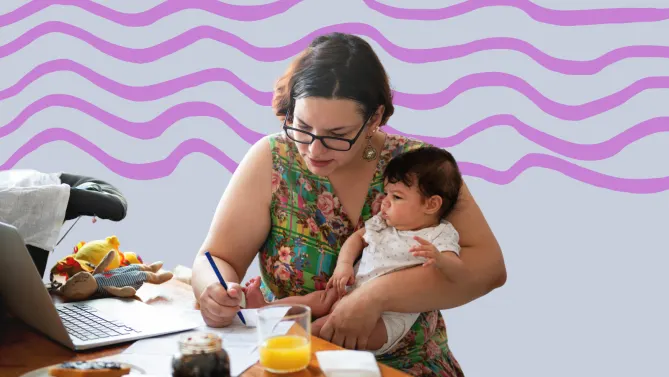 a mom working and holding her baby