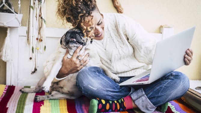 Woman on laptop with dog