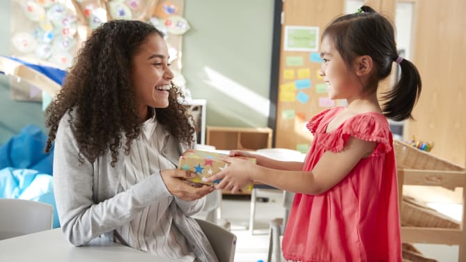 Child giving teacher a present 