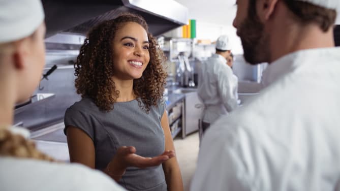 woman manager talking to servers