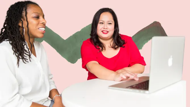 two women at work looking at a computer