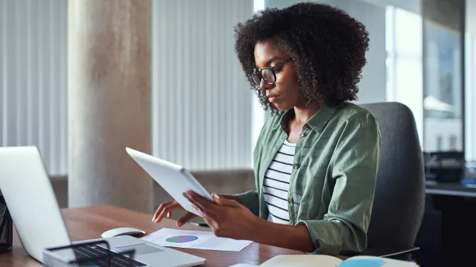 woman typing 30-60-90 plan on her laptop
