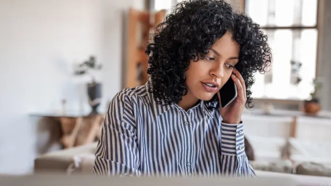 Woman sitting at desk talking on the phone