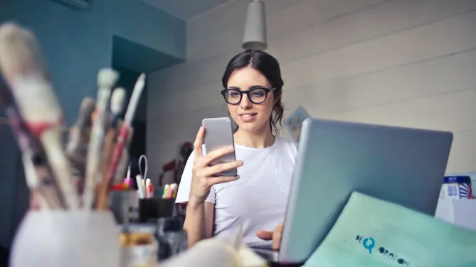 woman checking her phone at work