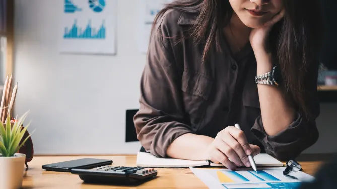 woman looking at 401(k) paperwork