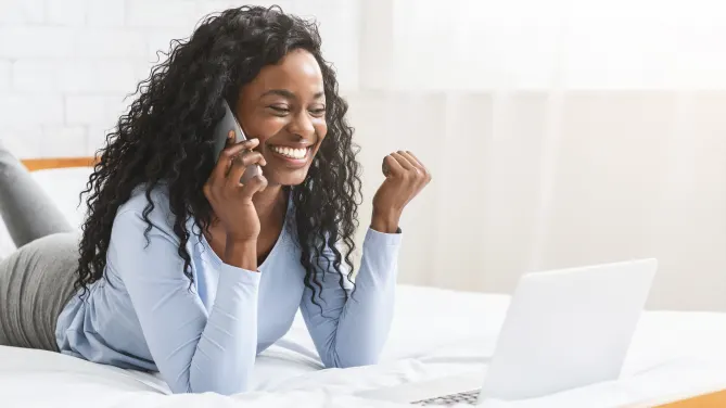 Excited woman on laptop
