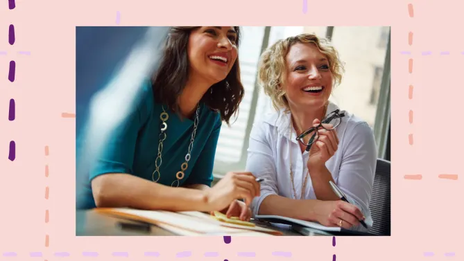 two woman smiling at work