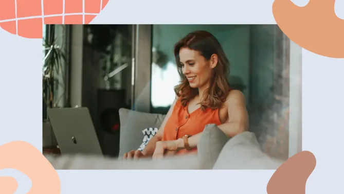 woman smiling while working on her laptop