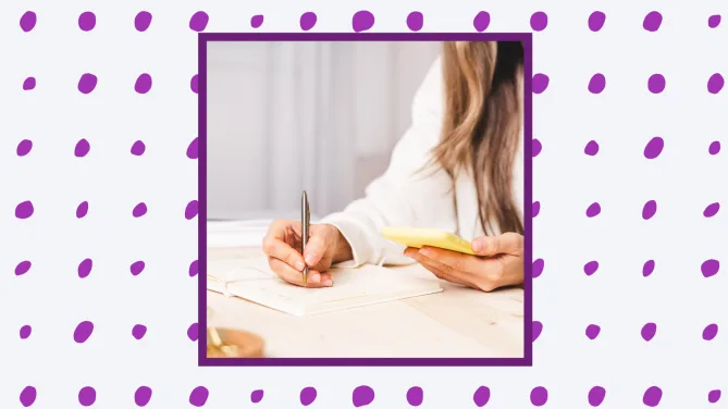 a woman writing on a sticky note. 