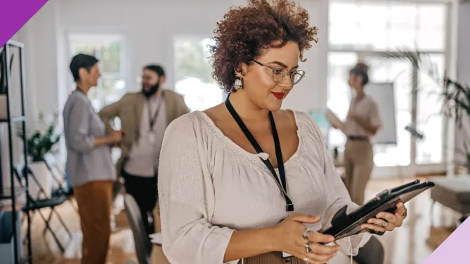 woman looking at ipad in office