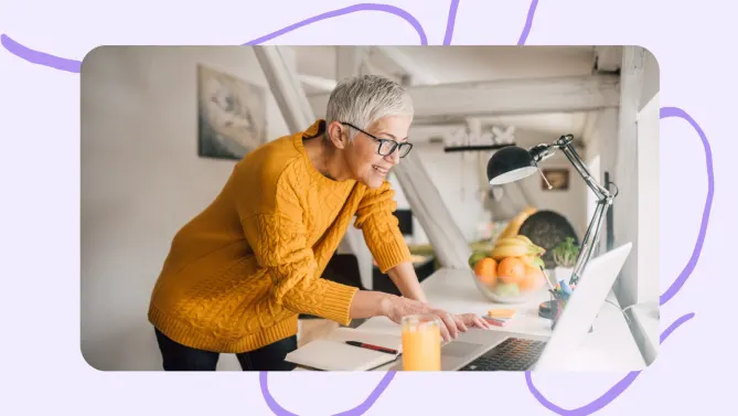 an older woman looking at a laptop.