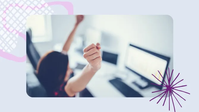 a woman raising her hands at a desk
