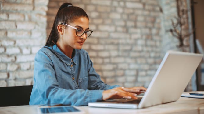 woman writing a cold email on her laptop