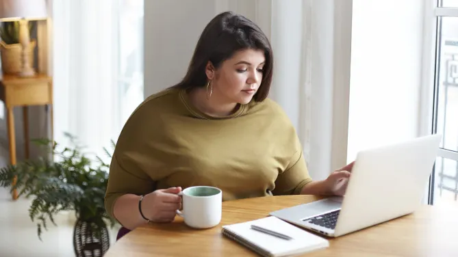 woman typing two-weeks' notice letter on her laptop