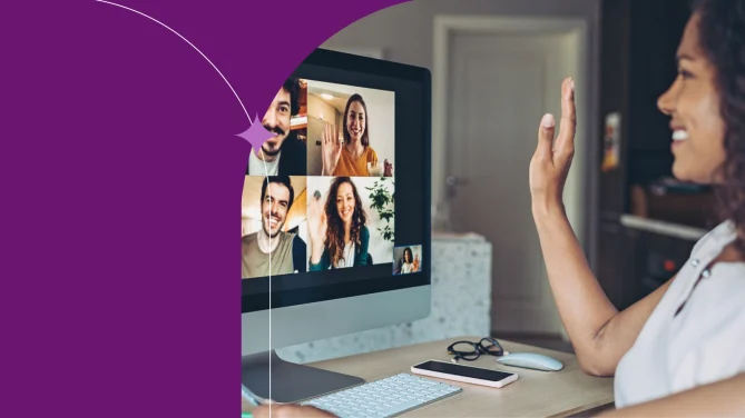 A person smiling and waving at their colleagues at a virtual meeting. 