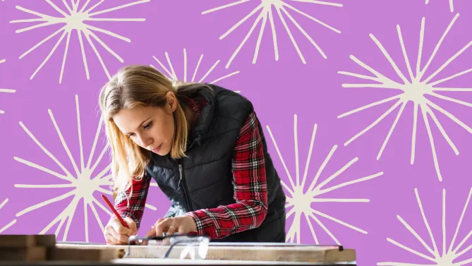 A woman bent over and working at a desk.