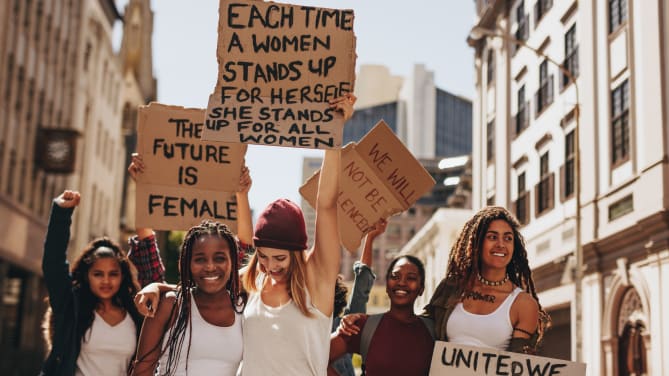 women rallying with signs