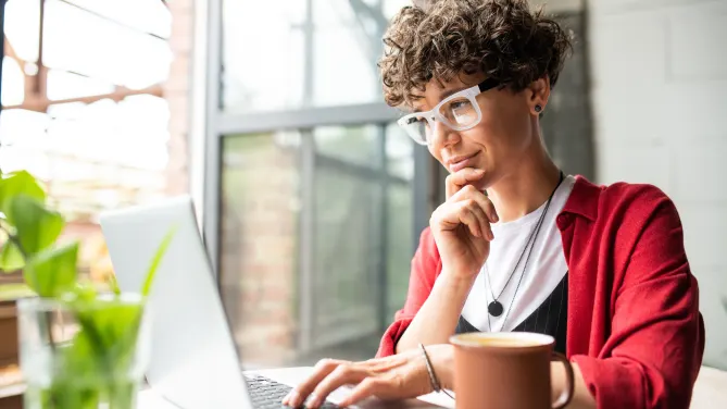 A woman types at a computer