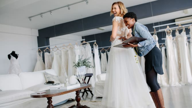 Woman trying on wedding gown
