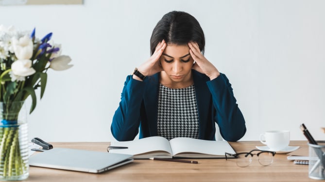 Stressed woman at her desk
