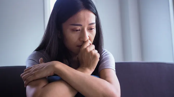 Sad woman on couch