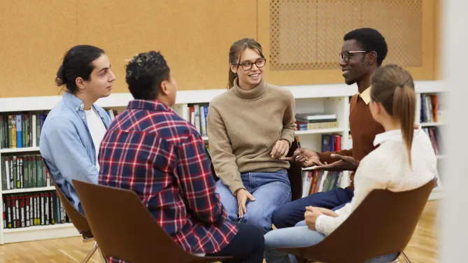 group of people sitting in a circle talking