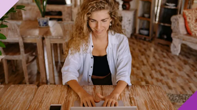 A woman at home typing on a laptop to illustrate how learning the differences between independent contractor vs employee is important to figure out what's best for your career